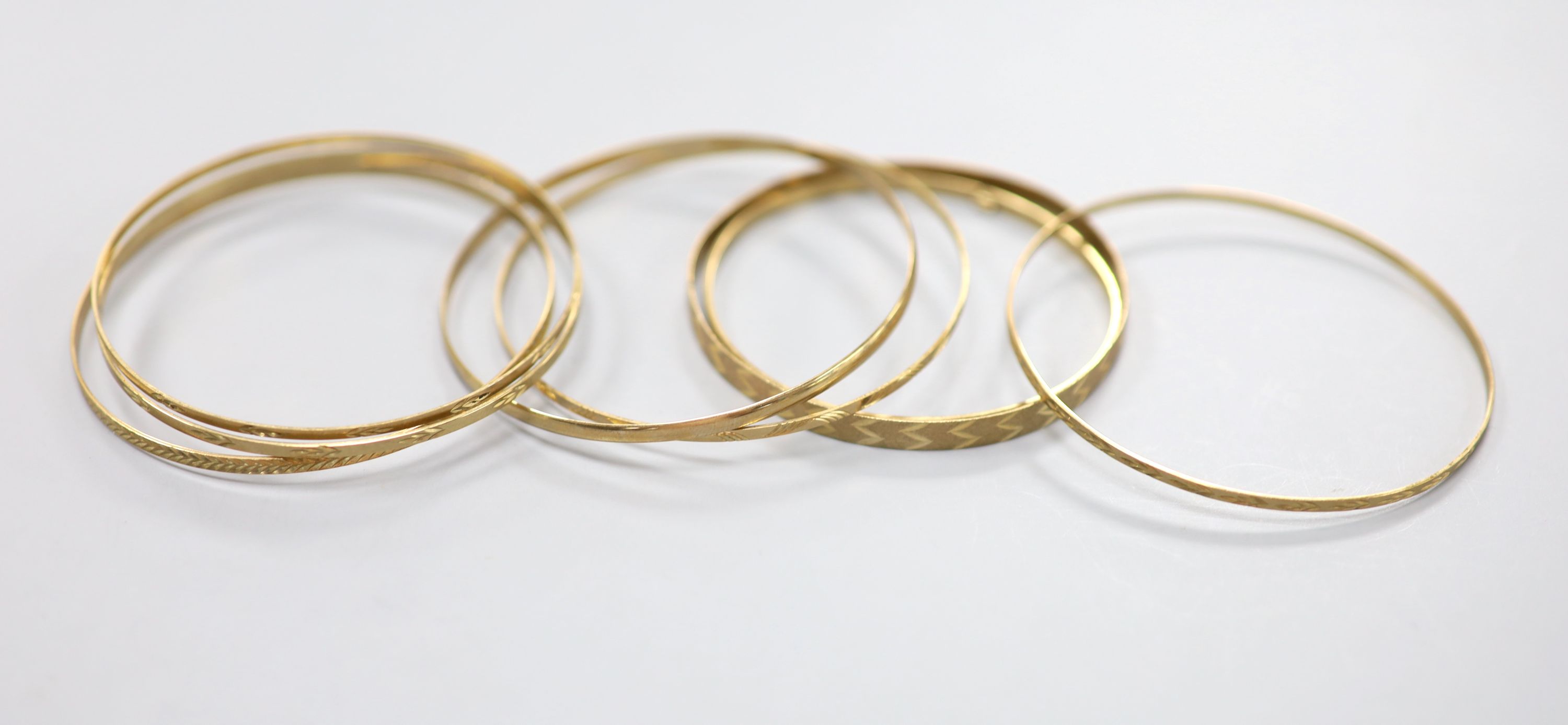 Eight assorted modern 9ct gold bangles
